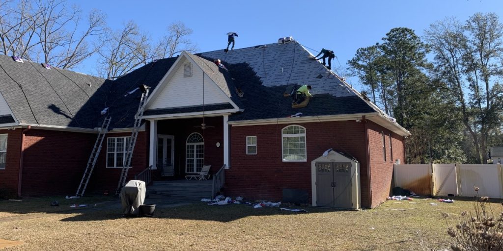 picture of men installing tiles on a roof