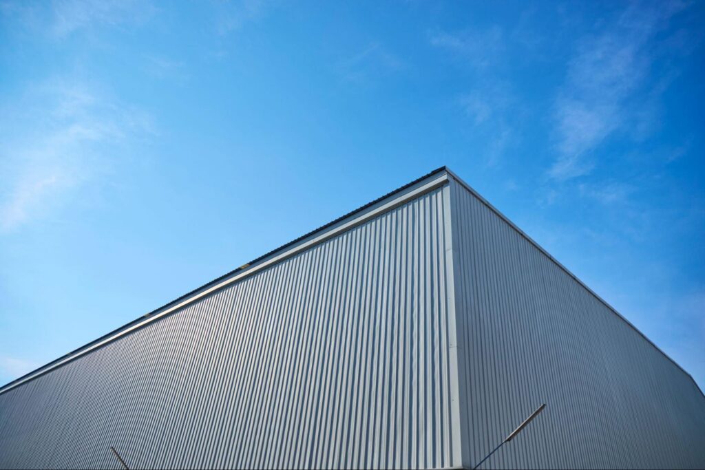 aerial shot of a steel building behind a bright blue sky