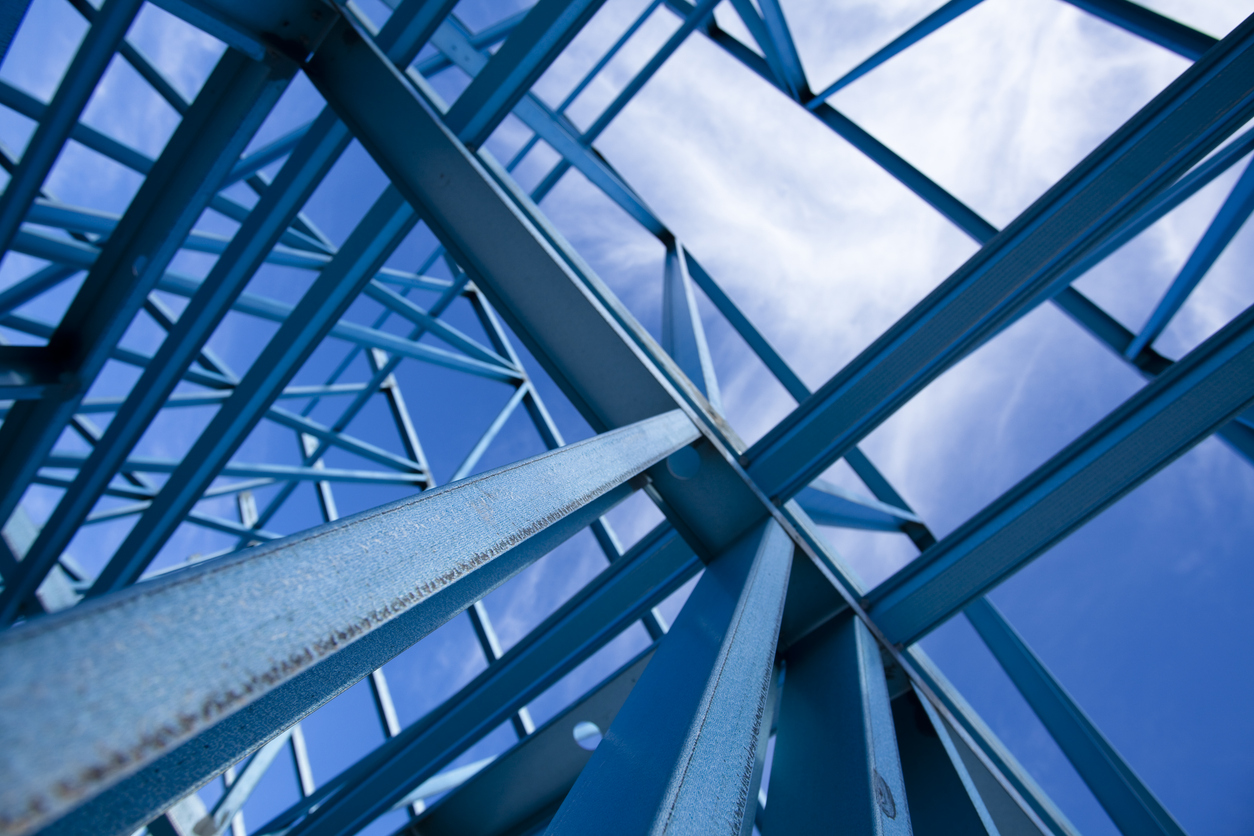 Modern steel architectural structure with geometric lines and blue tones viewed from below with strong composition.