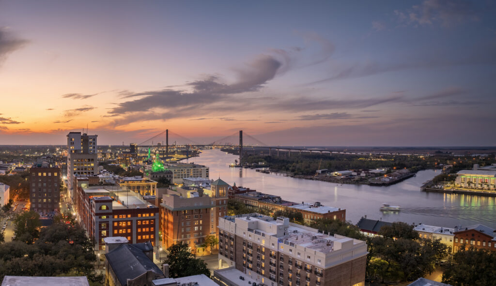 Waterfront River Street in Savannah, Georgia. Historic American architecture of old historical city. USA Southern cityscape at sunset.