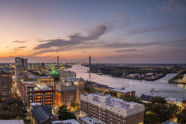Waterfront River Street in Savannah, Georgia. Historic American architecture of old historical city. USA Southern cityscape at sunset.